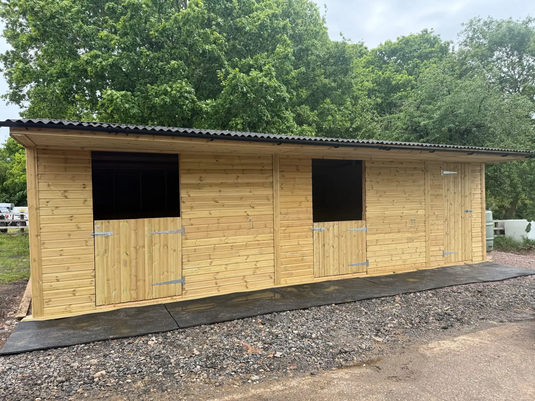 Long timber stable block with individual stable fronts